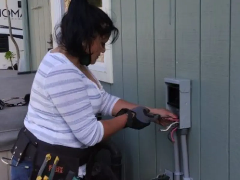 Licensed electrician wiring an exterior subpanel in Sherman